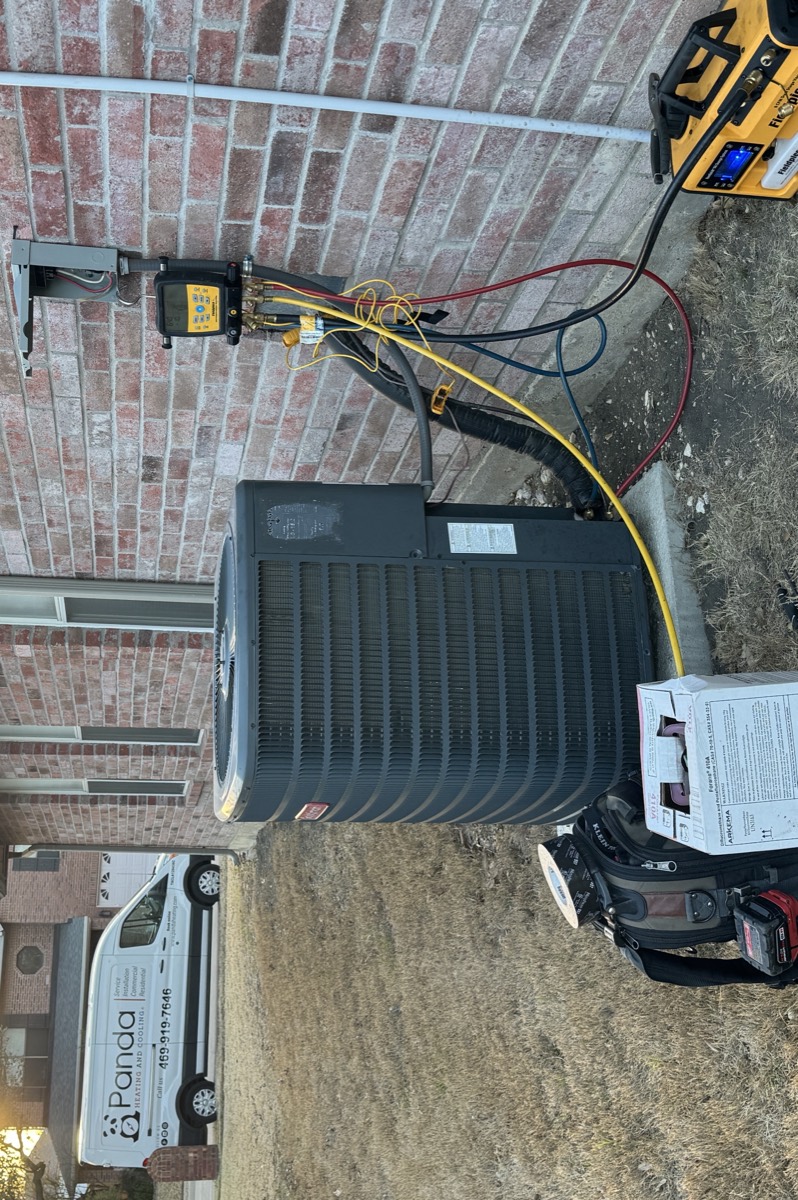 AC repair in progress on an outdoor condenser in Celina, TX, with digital manifold gauges connected at the service ports, R-410A refrigerant and a recovery machine on site, and the Panda Heating and Cooling van in the driveway