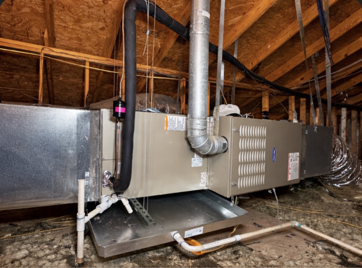 Carrier furnace and air handler professionally installed in an attic with a drain pan and sealed plenum in Celina, TX