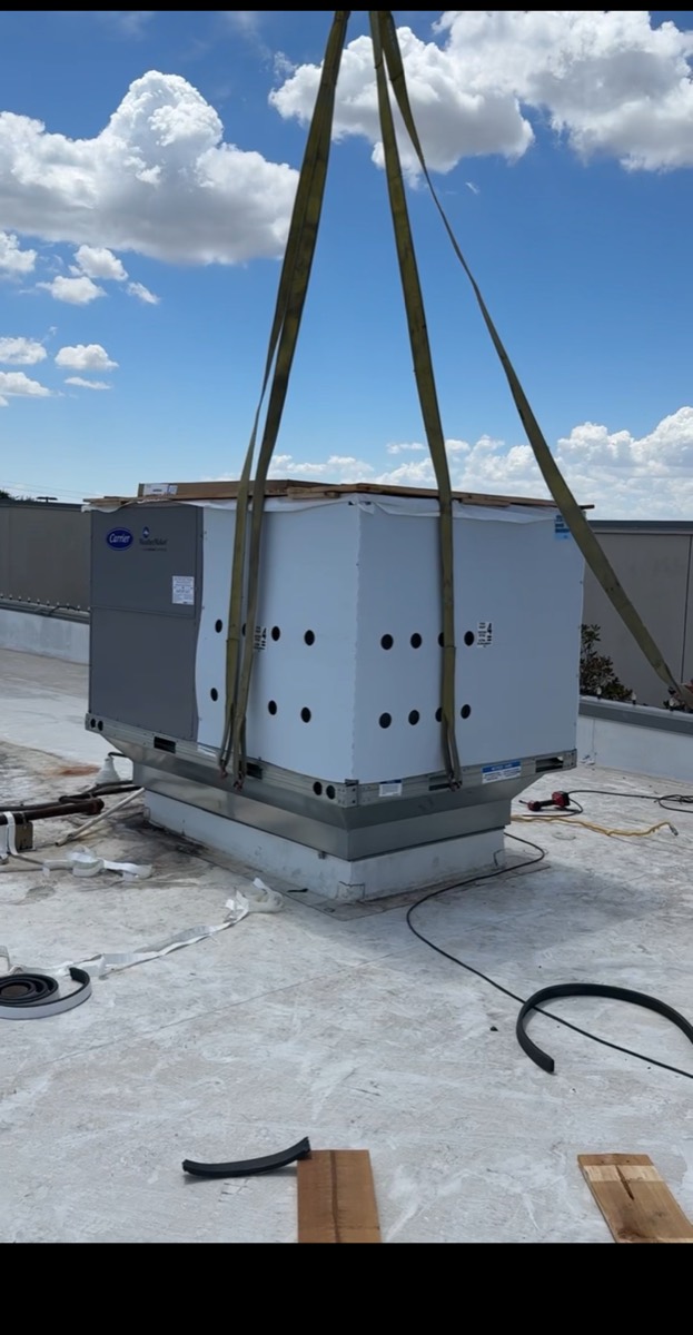Commercial Carrier rooftop unit landed on its curb and being connected during a restaurant HVAC installation