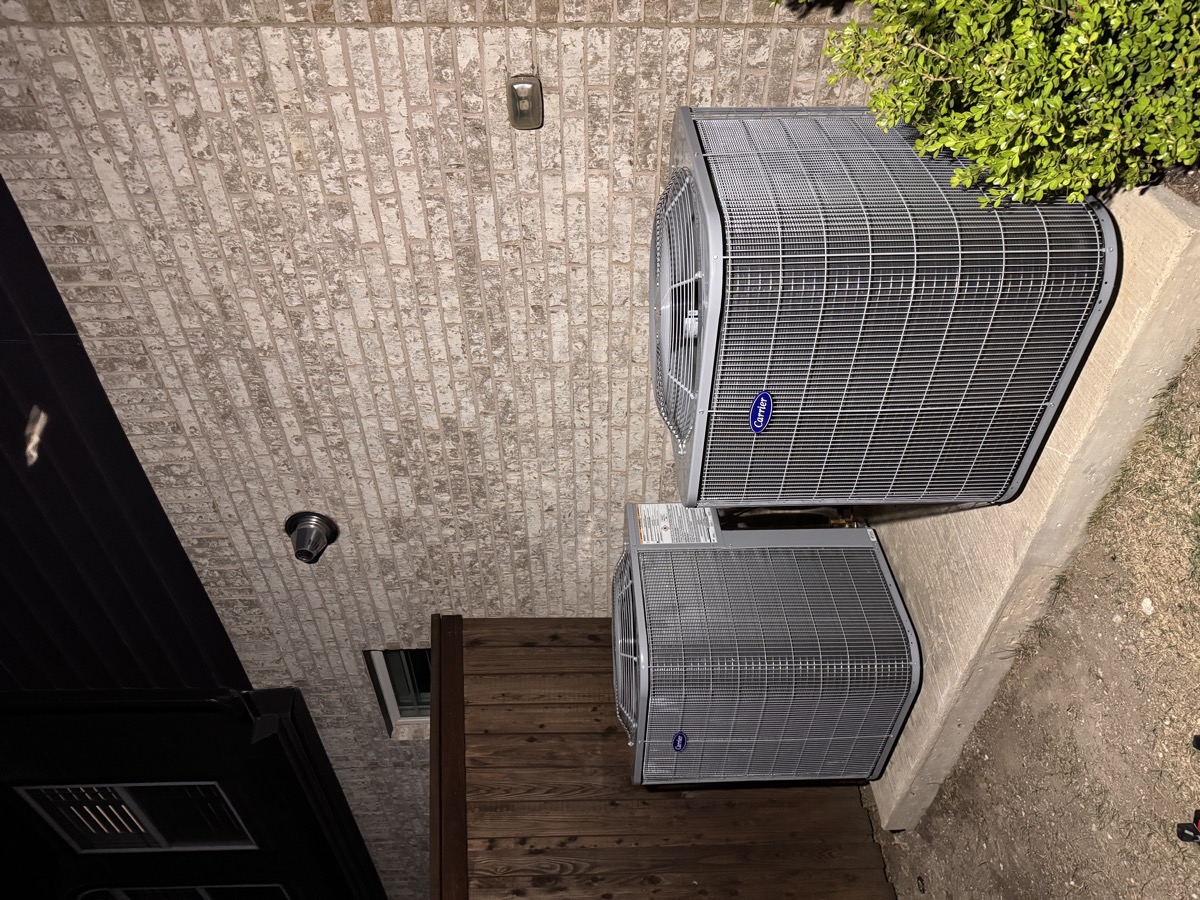 Two Carrier condensers installed by Panda Heating and Cooling at a two-system home in Celina, TX