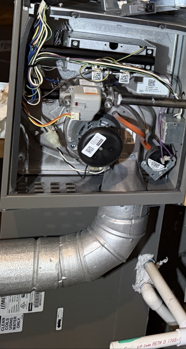 Attic gas furnace opened for repair in Celina, TX, showing the inducer motor, gas valve, pressure switch and control wiring, with the flue and Lennox cabinet in frame