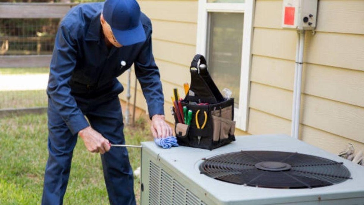 Technician diagnosing a noisy outdoor air conditioning unit in Celina, TX